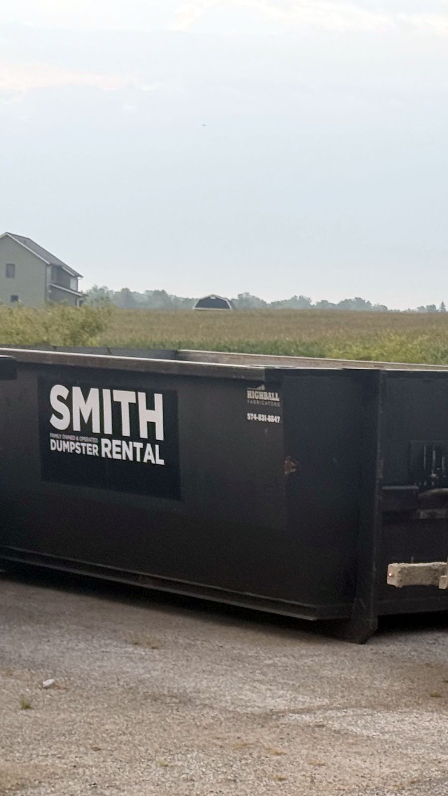 Smith Dumpster Rental roll-off truck hooking a dumpster